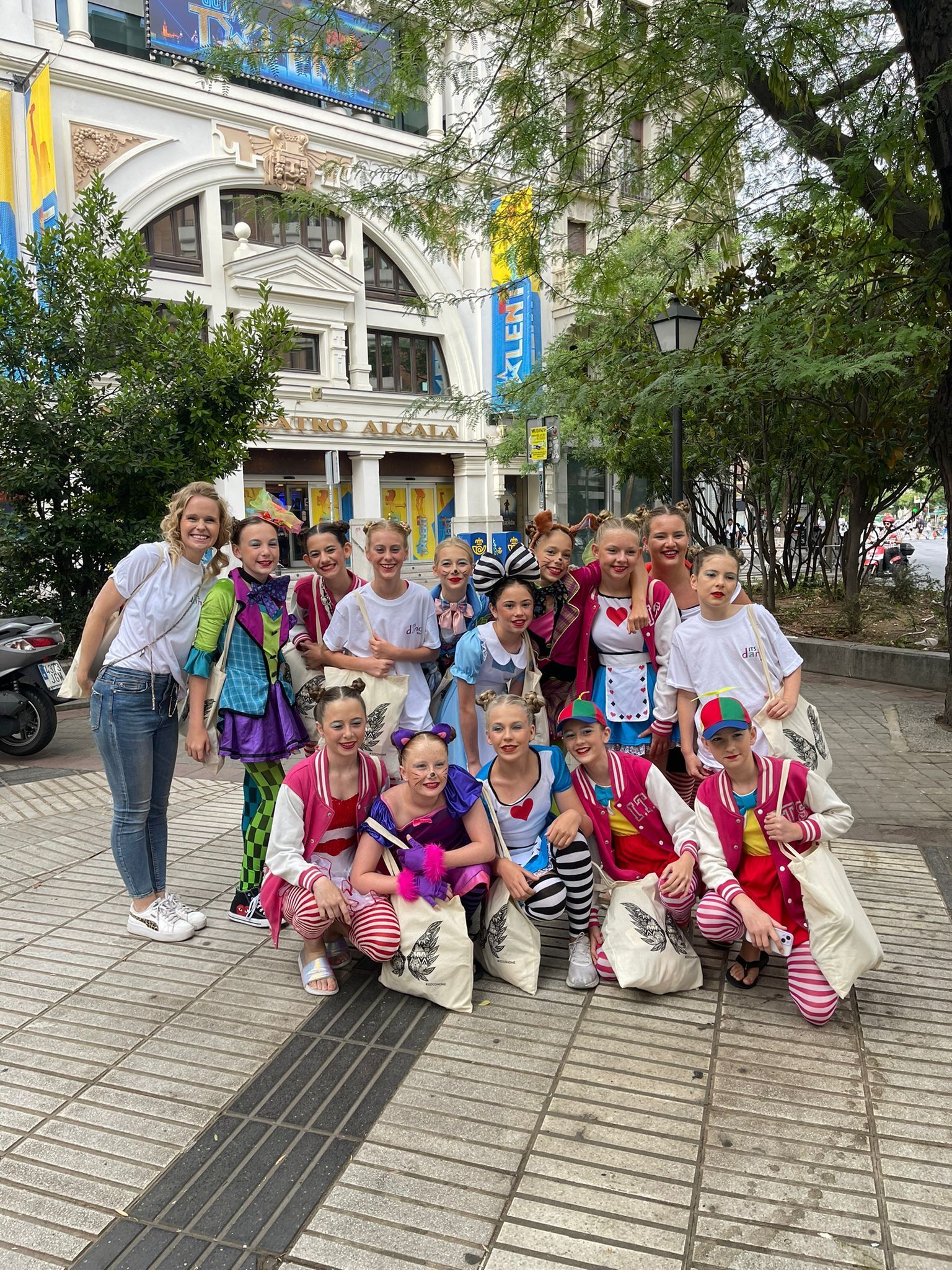 A group of children are posing for a picture in front of a building.