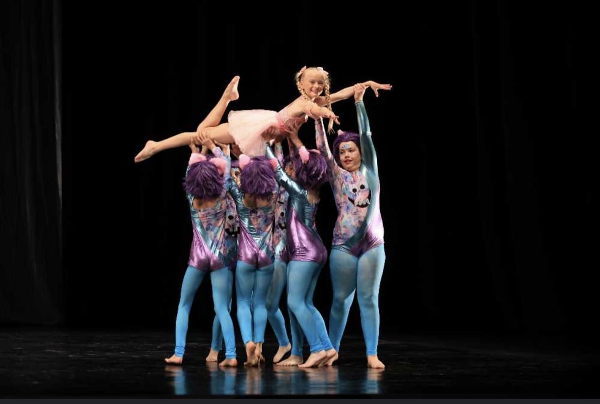 A group of dancers are performing on a stage.