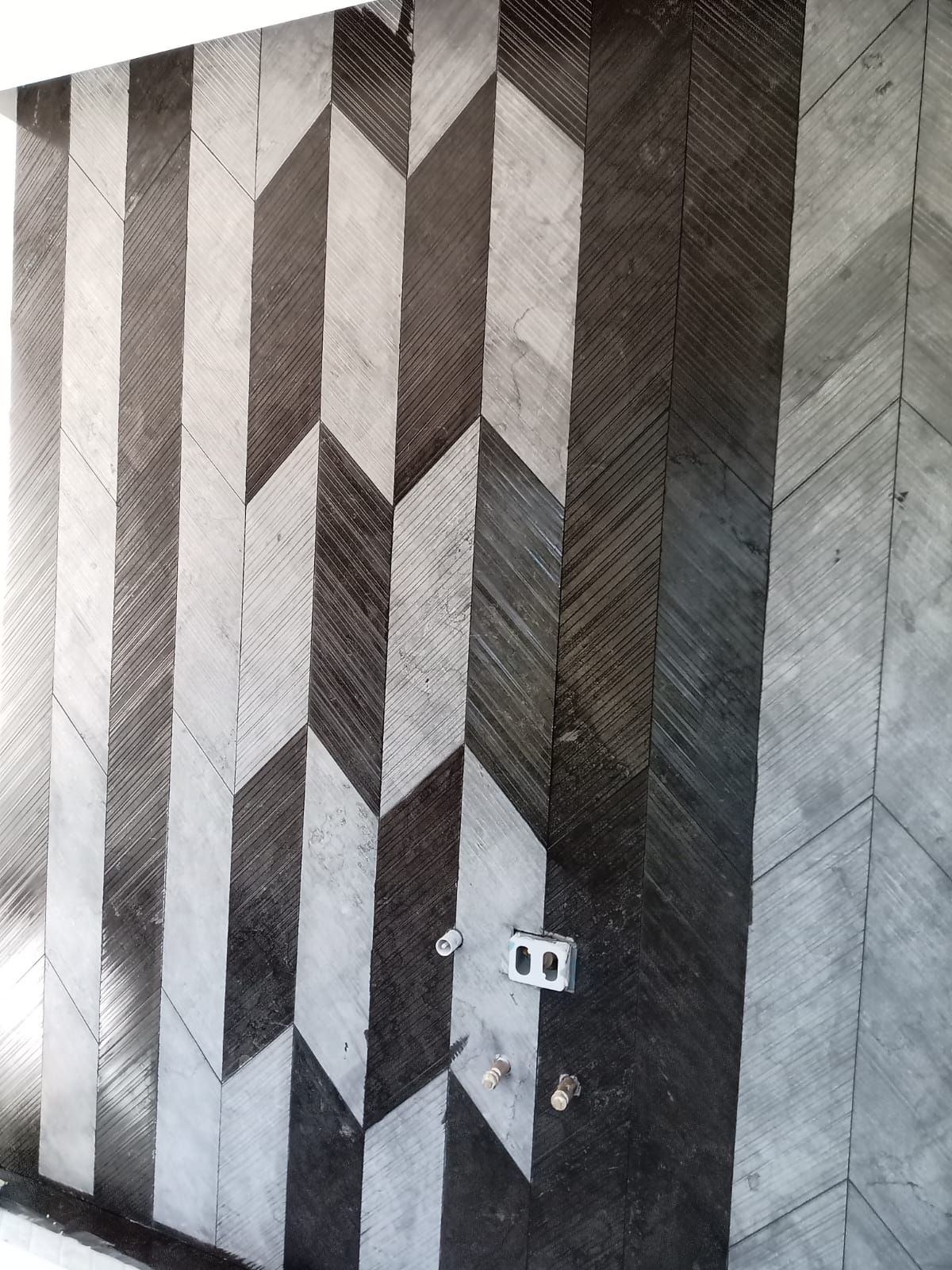 Un mur noir et blanc avec un motif géométrique dessus