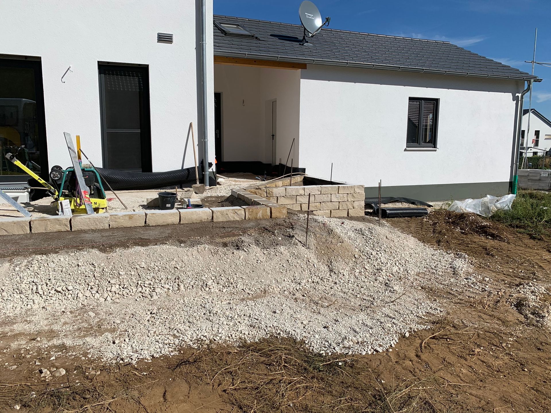 Vorbereitung einer Pflasterfläche vor Einfamilienhaus