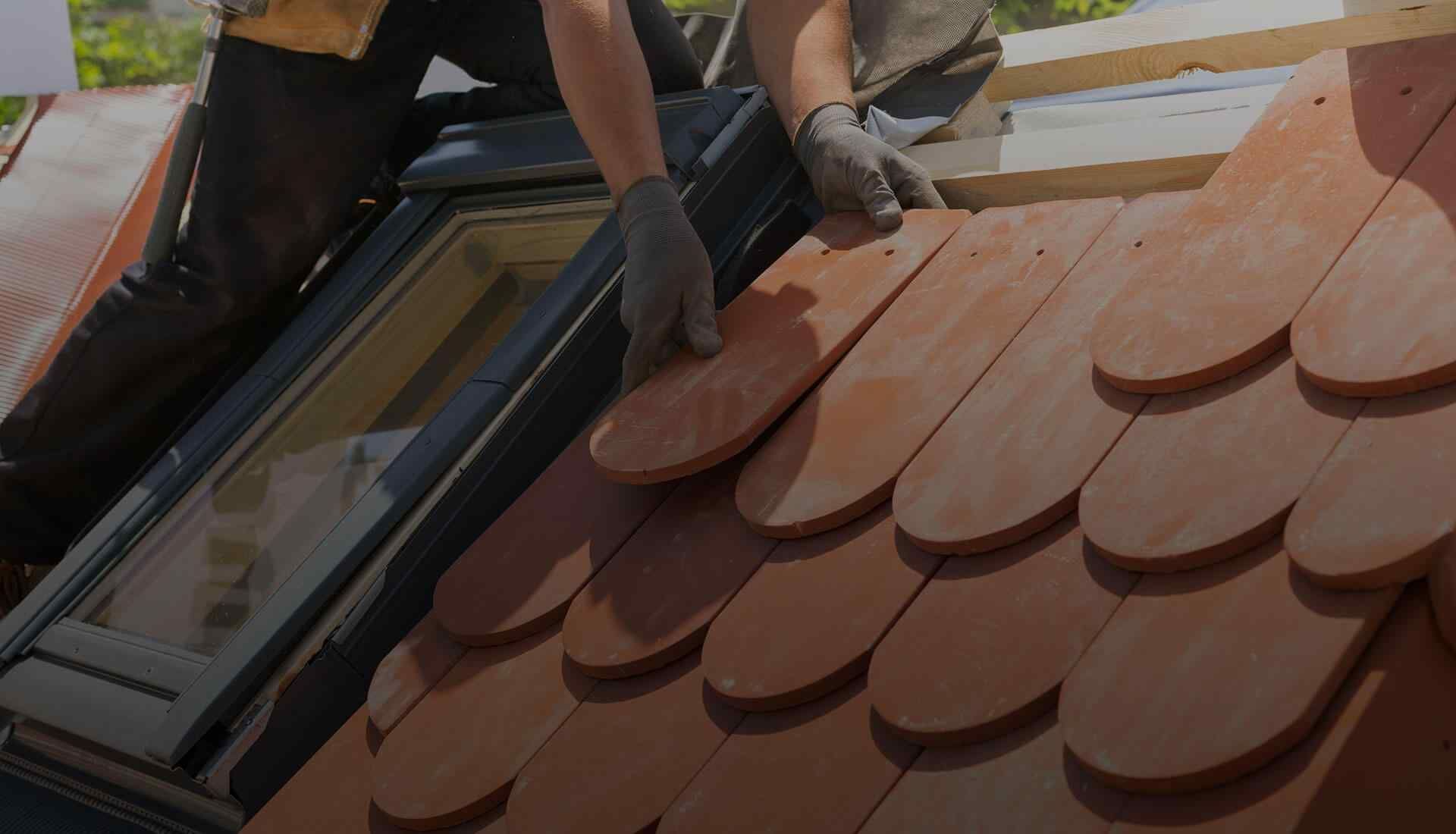 Professionnel remplaçant des tuiles plates et arrondies