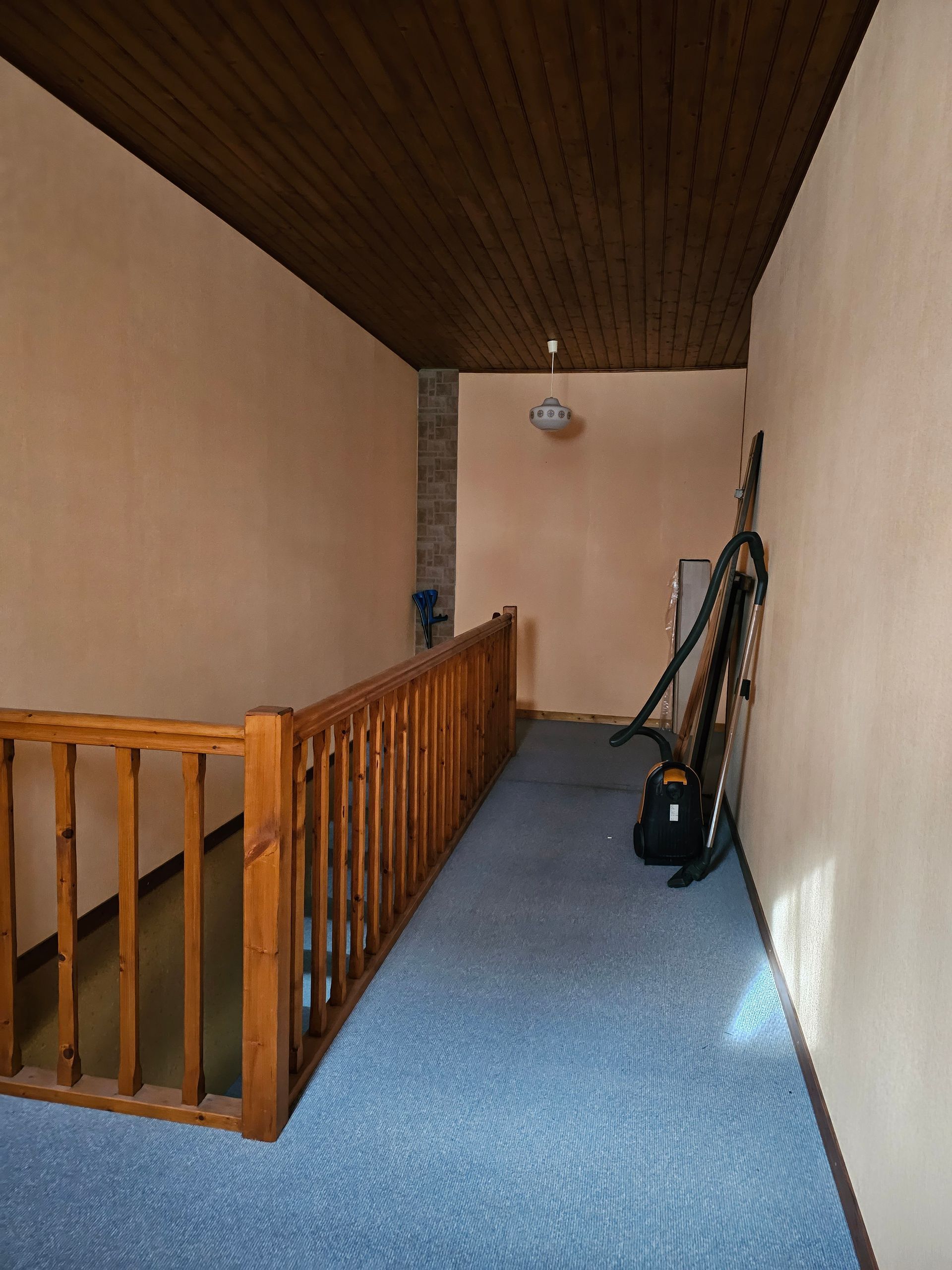 Haut d'un escalier avec de la moquette bleue