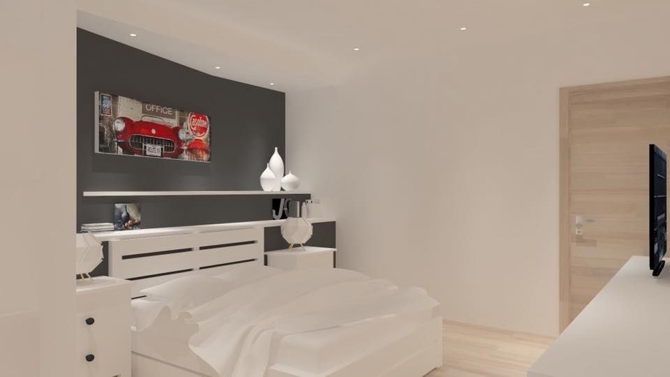 Un dormitorio con cama, cómoda, escritorio y televisión.