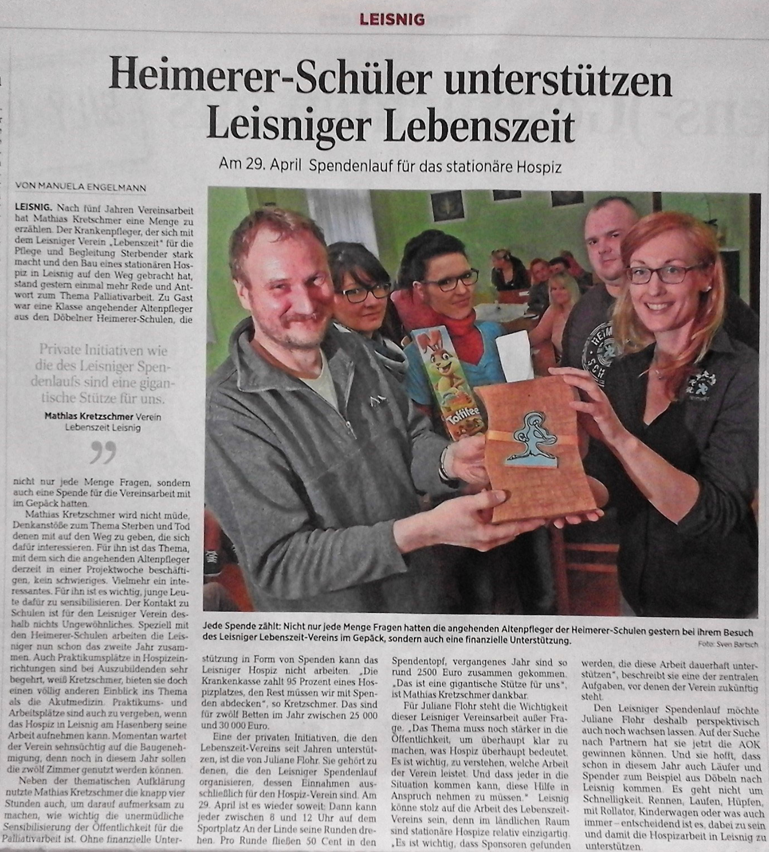 Ein Zeitungsartikel mit einem Foto von Menschen, die eine Spendenbox für die Organisation Leisniger Lebenszeit halten.