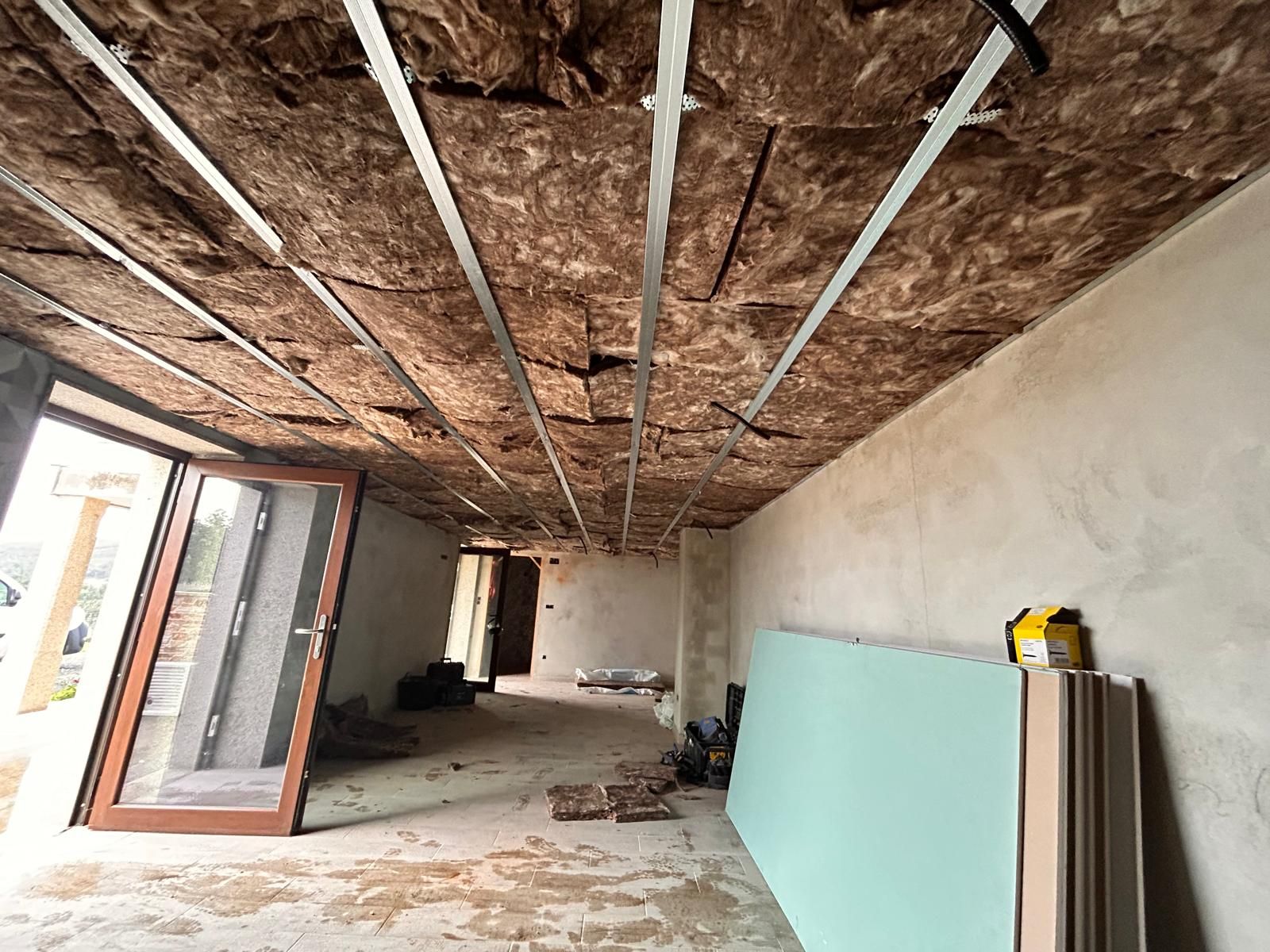 Una habitación con un techo que se está construyendo y una puerta.