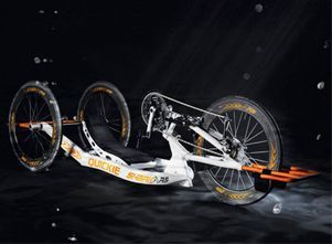 Un triciclo con tres ruedas está sentado sobre una superficie negra.