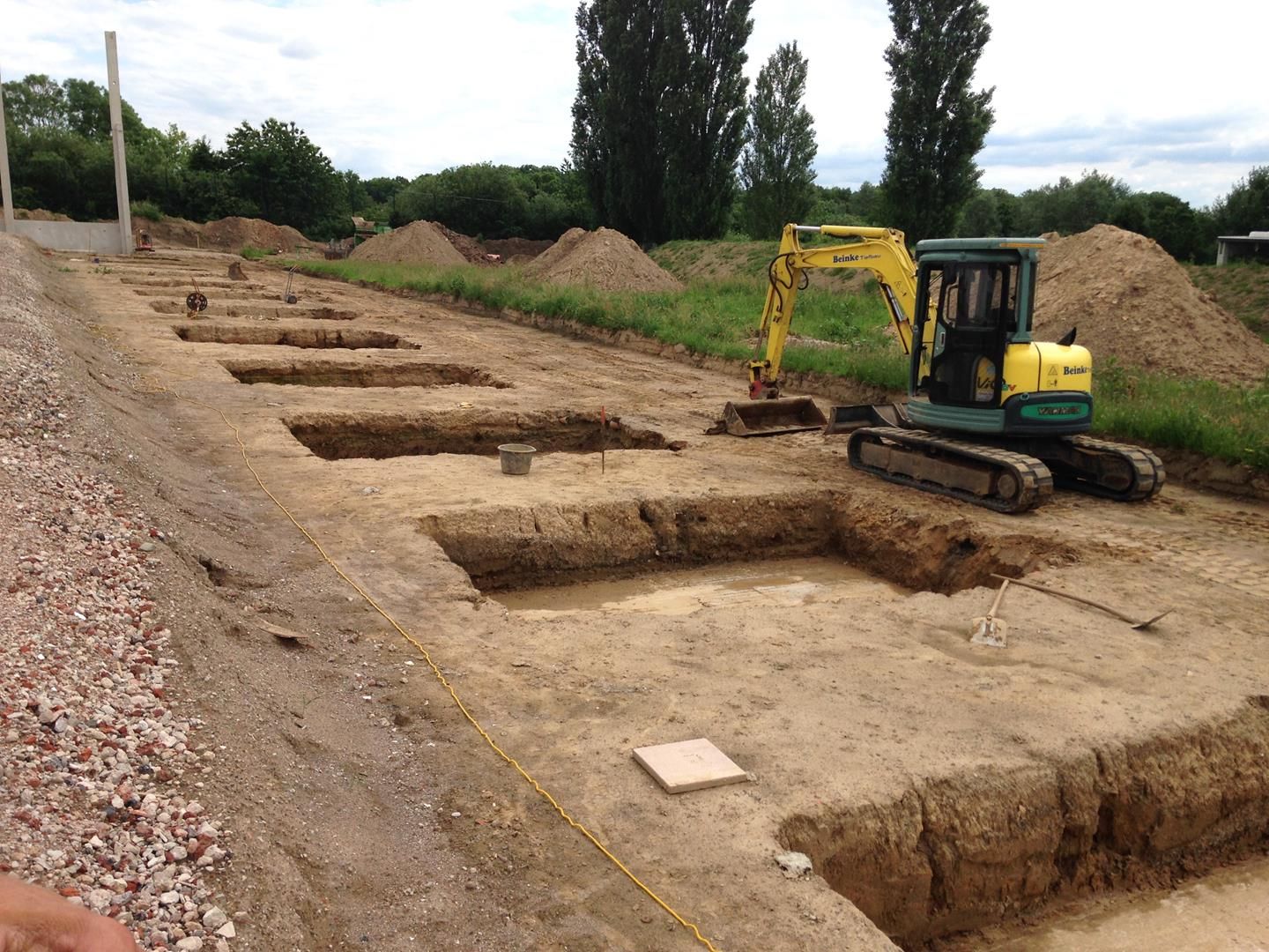 Ein gelber Bagger arbeitet auf einer Baustelle