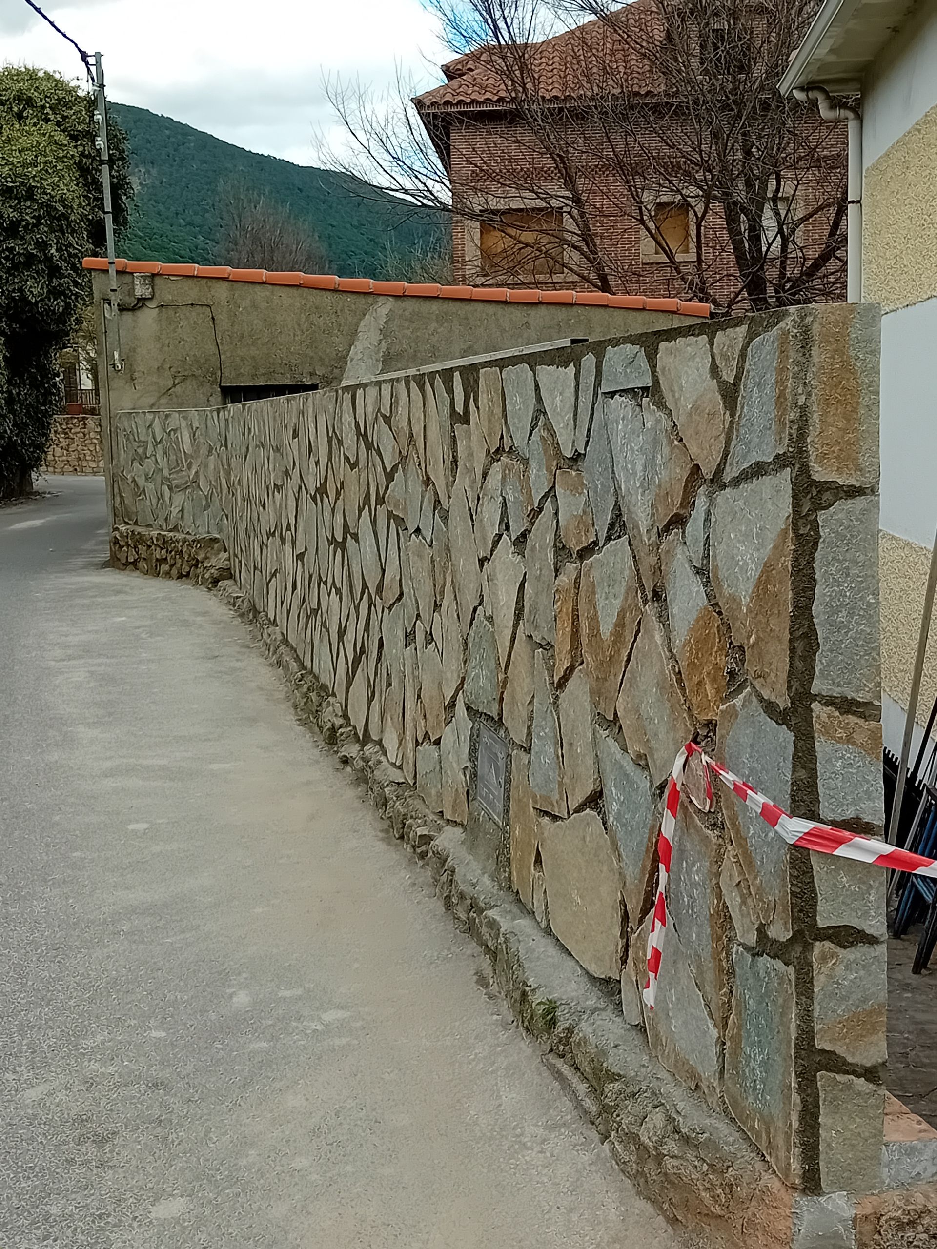 Un muro de piedra al costado de una carretera