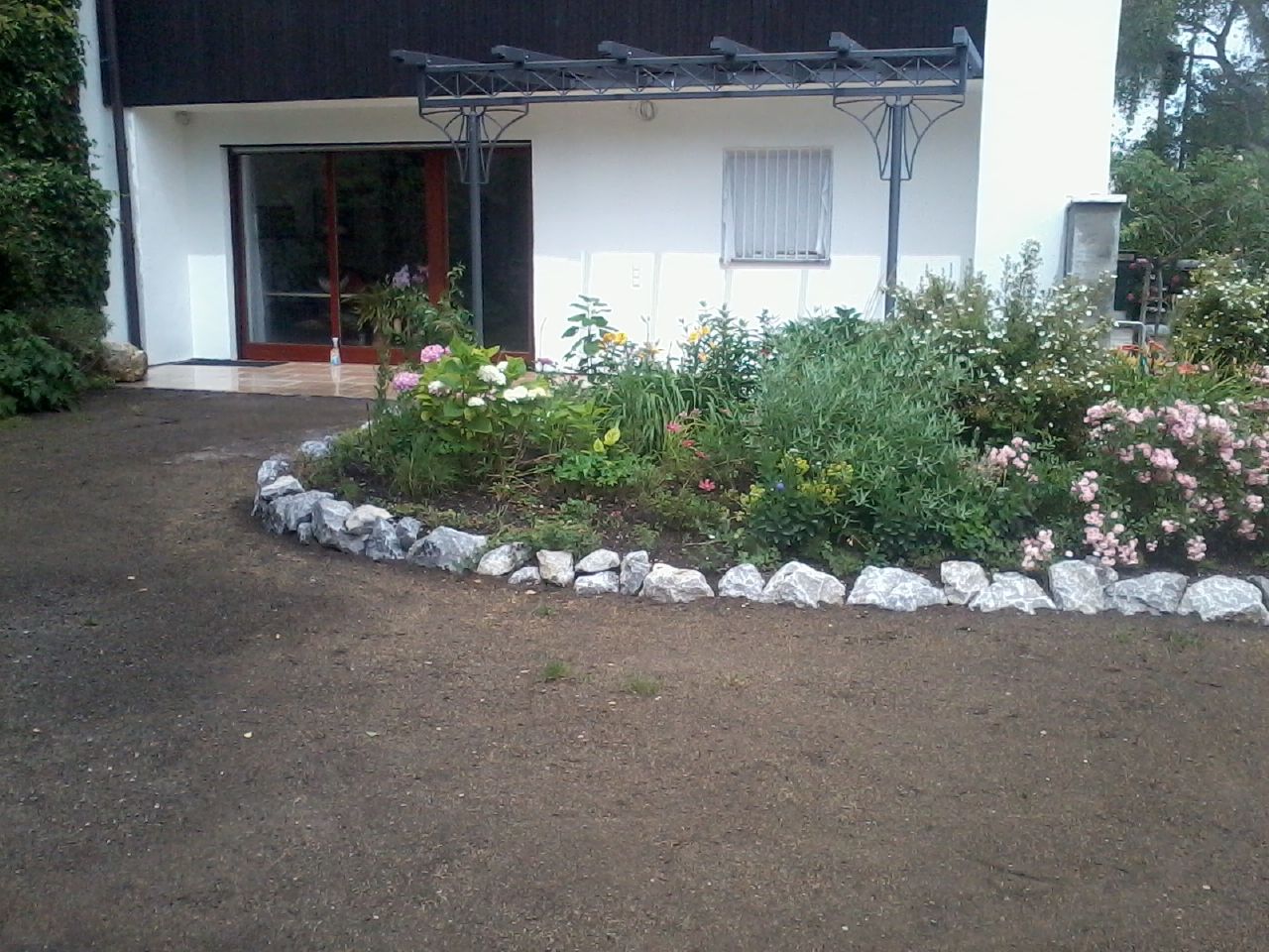 Gepflegtes Blumenbeet vor einem Haus, Foto von Martin Deuflhart