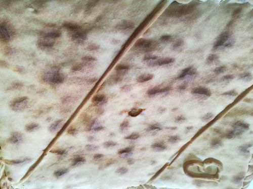 Un primer plano de un trozo de pan con la letra b.