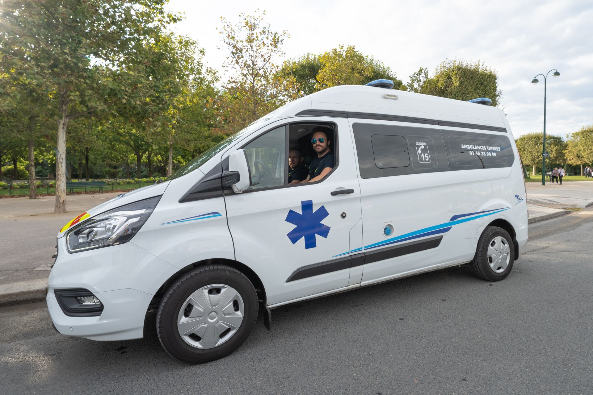 Ambulancier portant des lunettes de soleil au volant de son ambulance