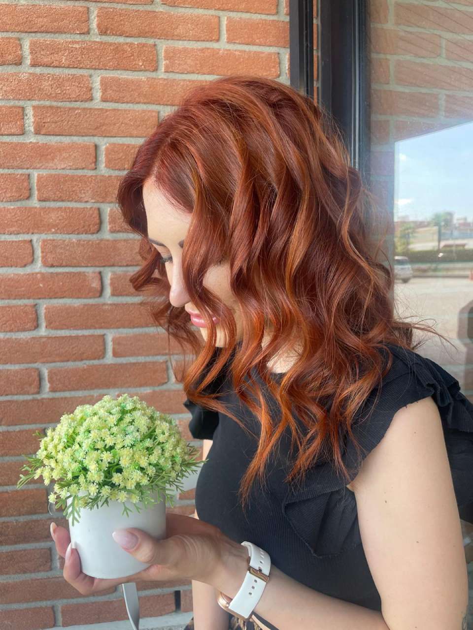 Profilo laterale di una persona con capelli corti color rame.