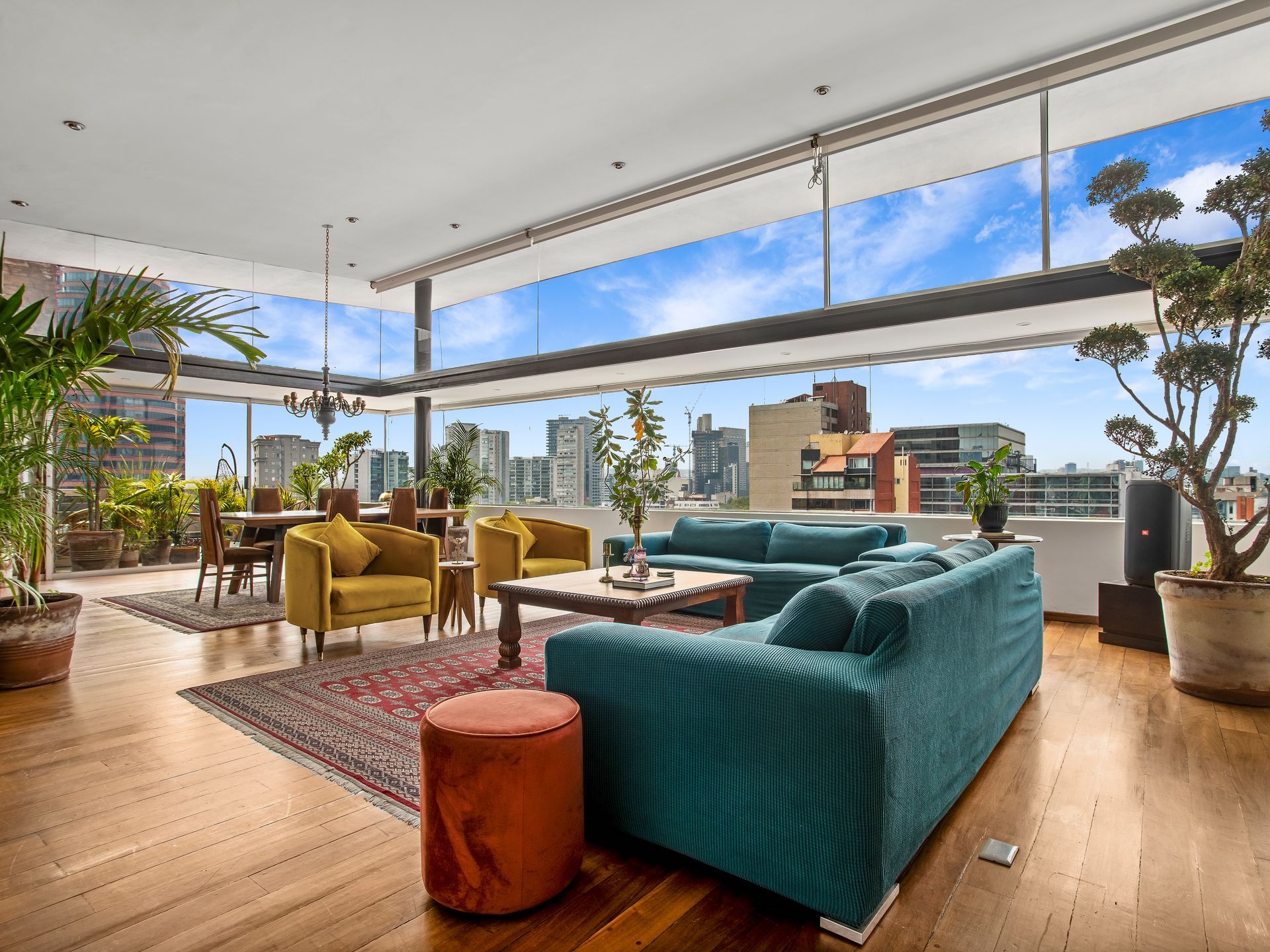 A living room with a blue couch and yellow chairs