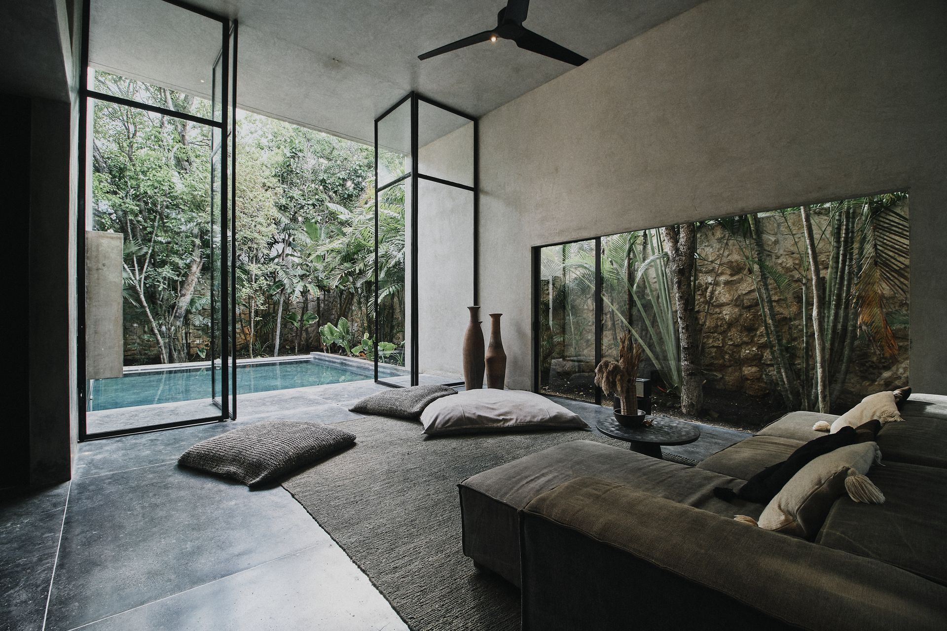 A canopy bed is sitting on top of a wooden deck.