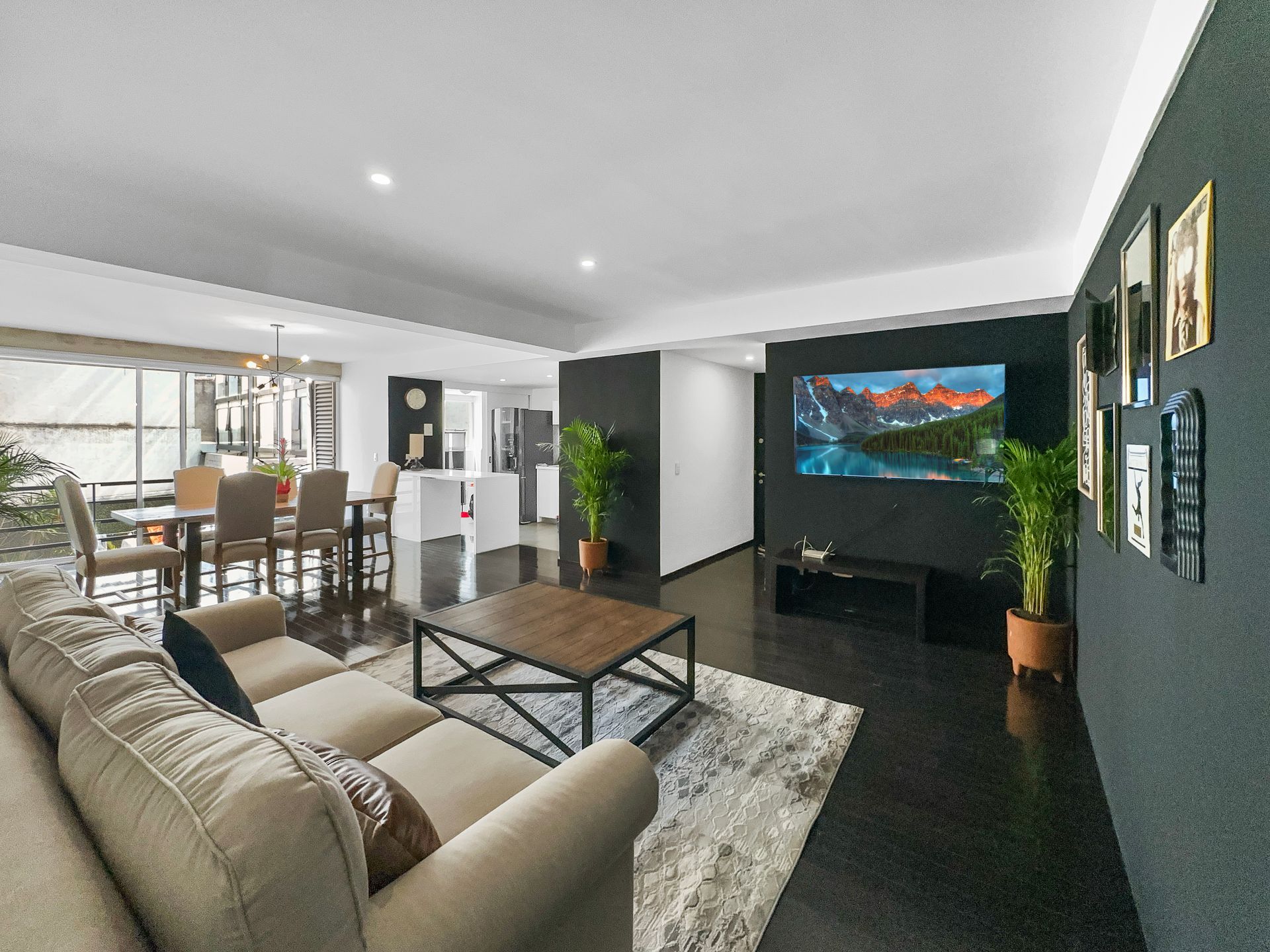 A living room with a couch , coffee table , and television.