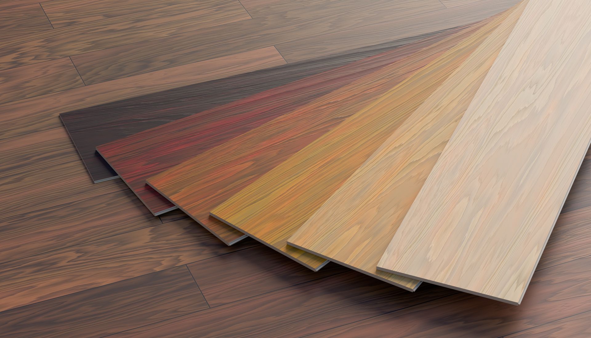 Échantillons de parquets en bois de différentes couleurs, présentés sur un sol en bois.