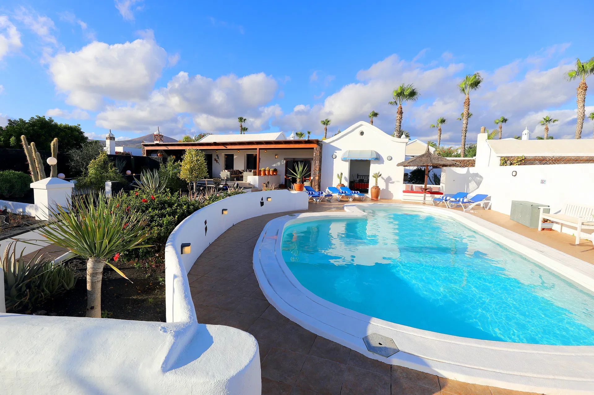 White villa with blue pool and sunny sky. Villa Salvo | Los Mojones | Puerto del Carmen | Lanzarote.