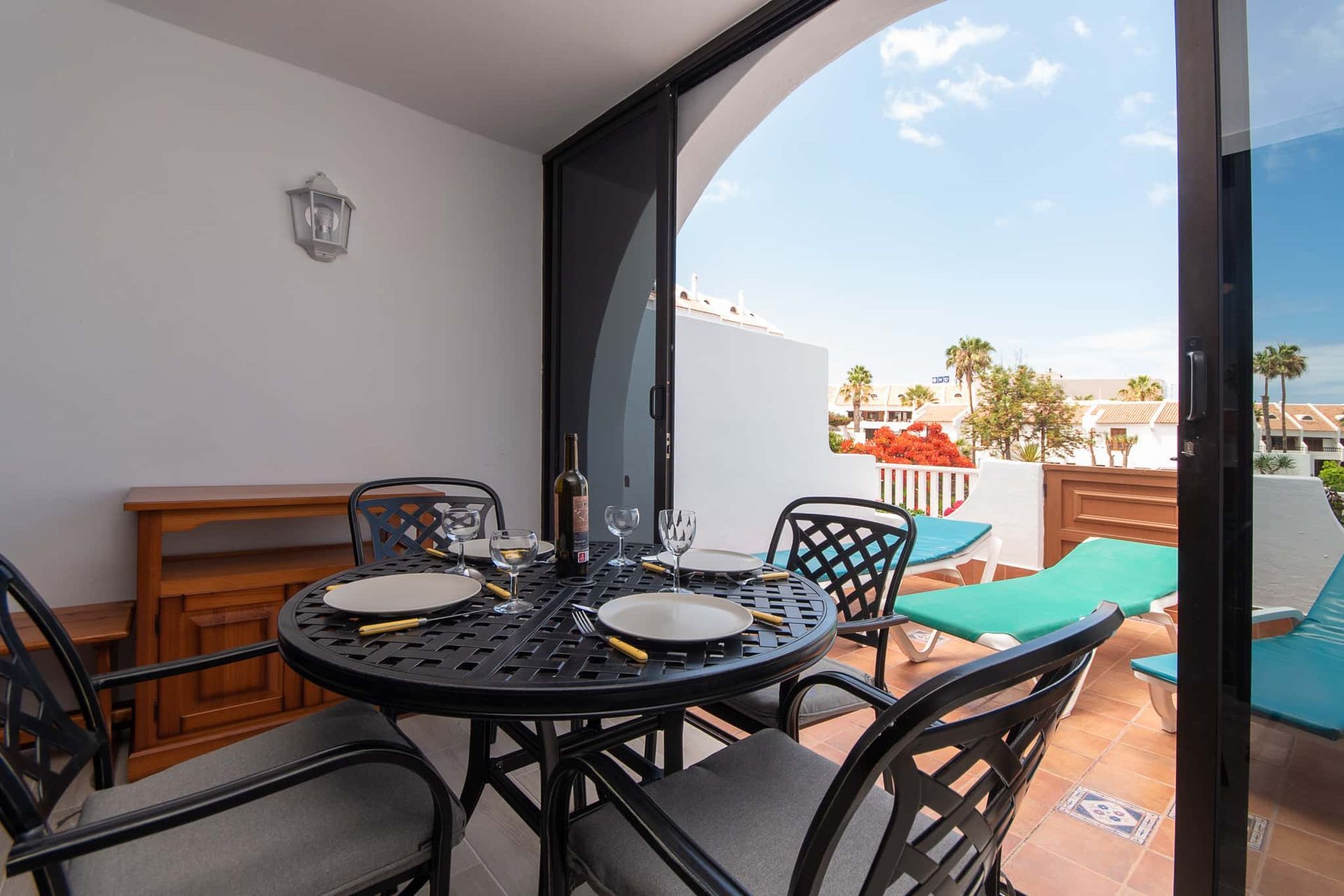 Terrace with patio table and chairs, with sun loungers at Parque Santiago II, Playa de las Americas, Tenerife