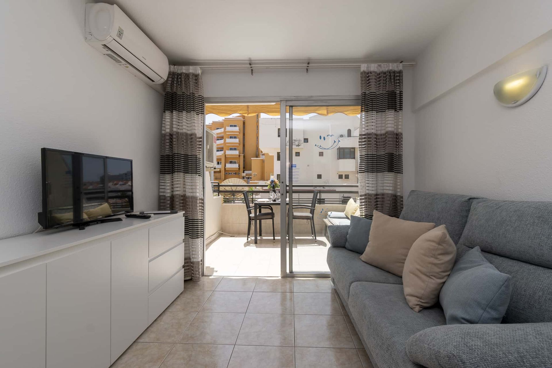 Lounge with sofa, flat screen TV with English and international channels, air conditioning, patio doors out to balcony, Santa Maria, Costa Adeje, Tenerife