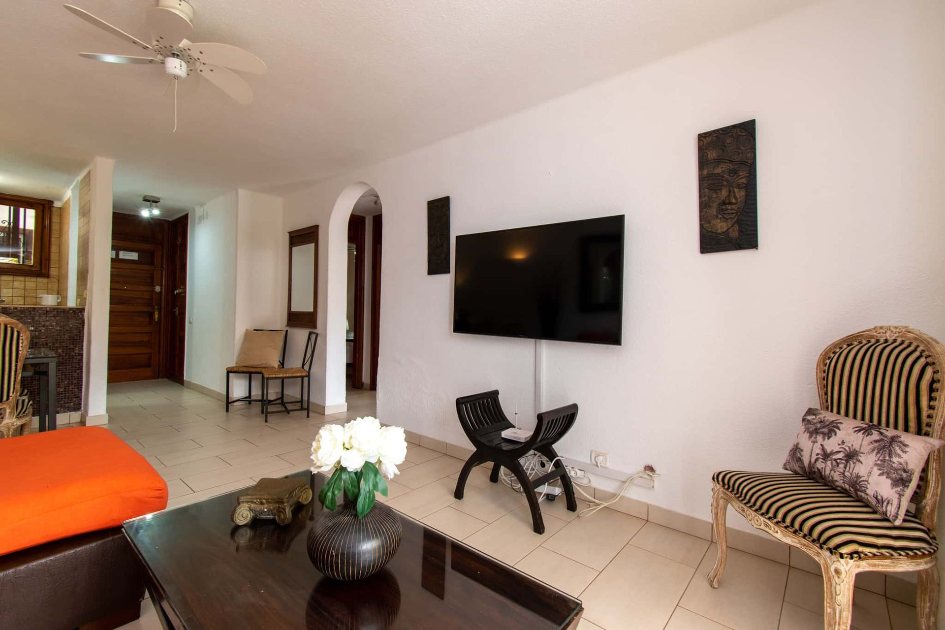 Lounge with wall-mounted TV, wifi router, chair, table, Parque Santiago I, Playa de las Americas, Tenerife