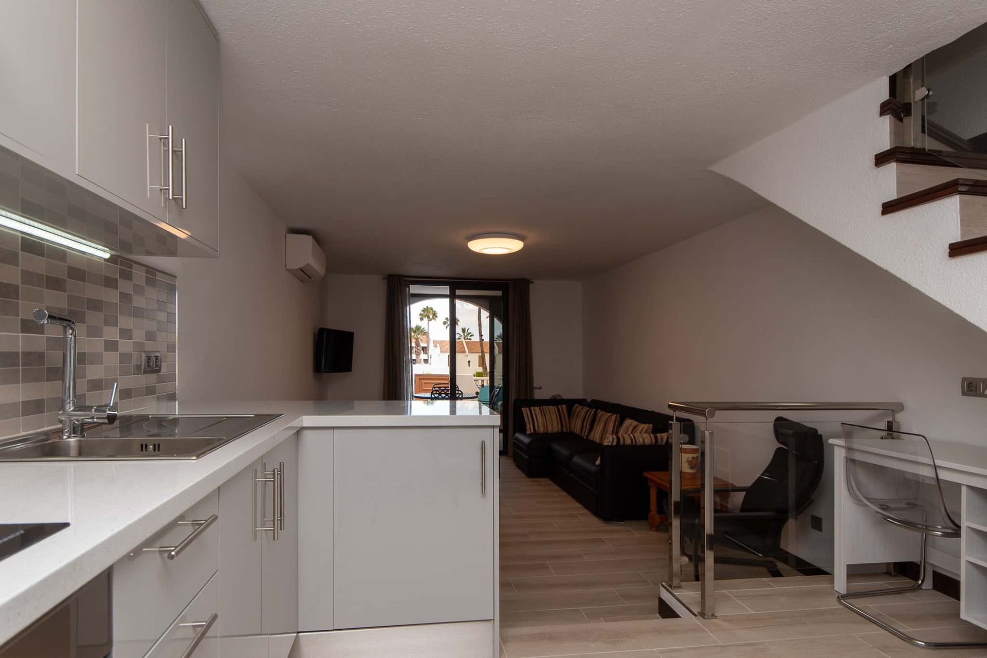 Kitchen, sofa, armchair, desk and chair, air conditioning at Parque Santiago II, Playa de las Americas, Tenerife