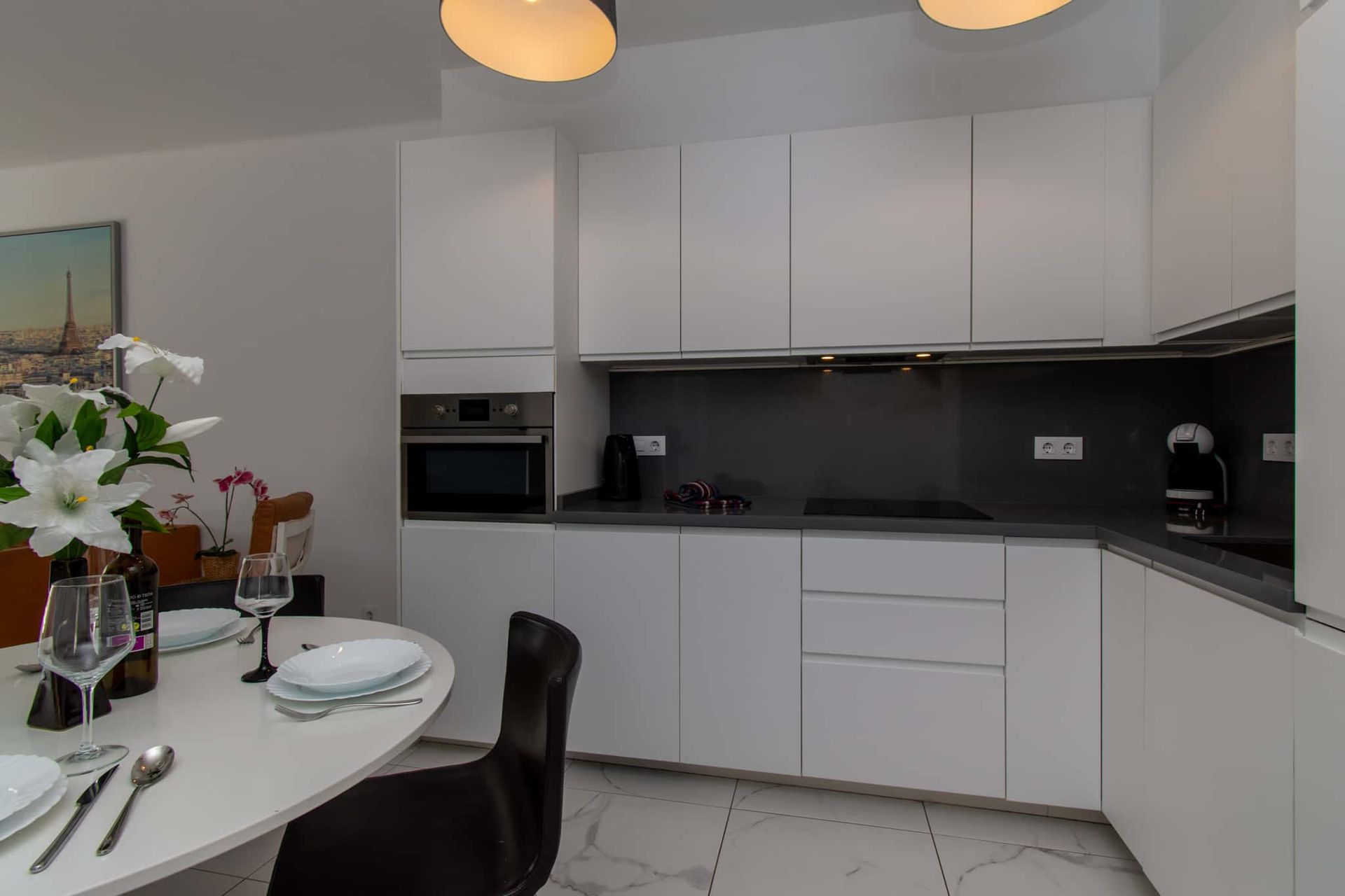 Kitchen with oven, coffee maker, dining table and chairs, Club Atlantis, Costa Adeje, Tenerife.