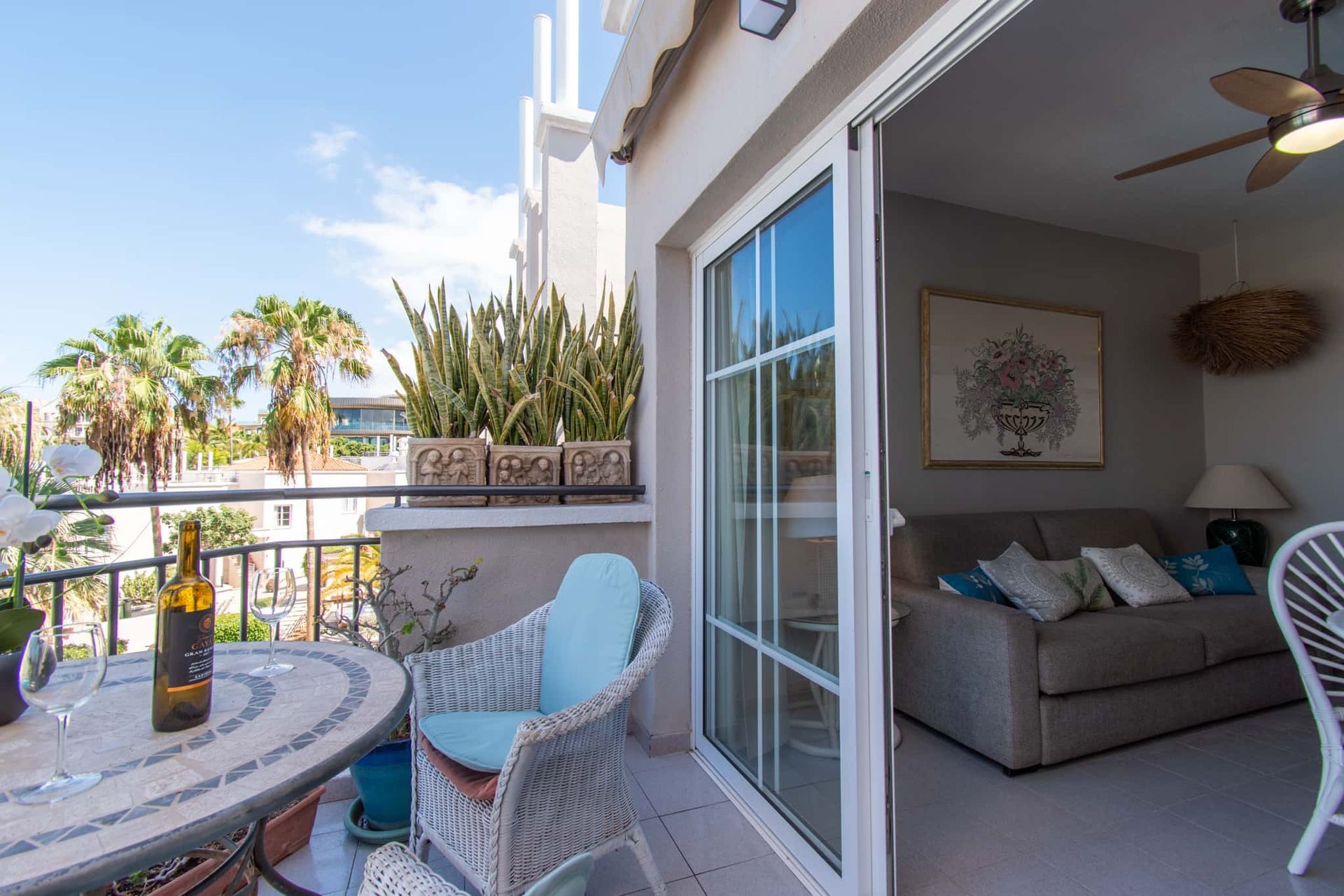 Balcony with patio table and chiars, patio doors leading into living room, Los Olivos, Costa Adeje, Tenerife.