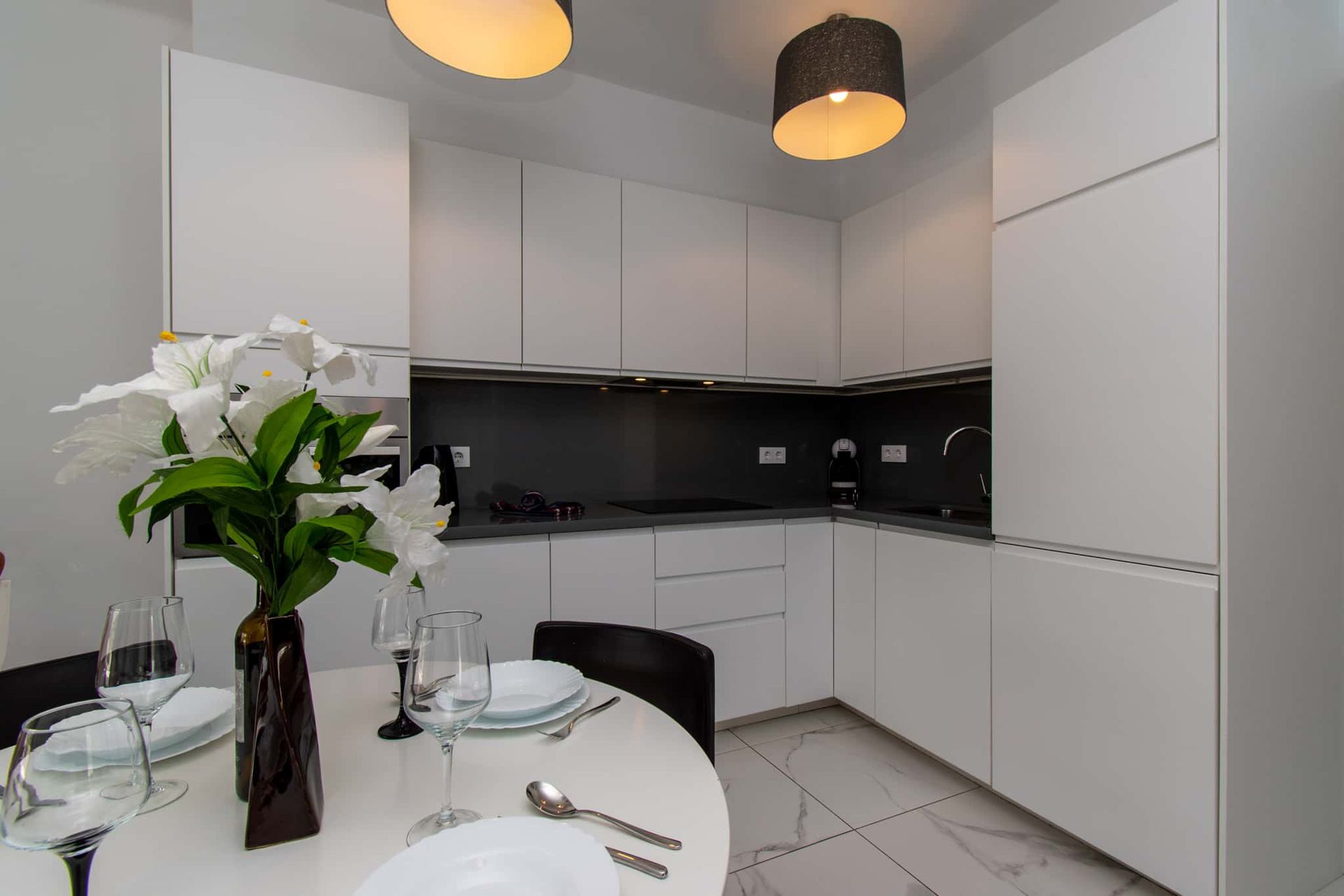 Kitchen with dining table and chairs, oven, coffee maker, Club Atlantis, Costa Adeje, Tenerife.
