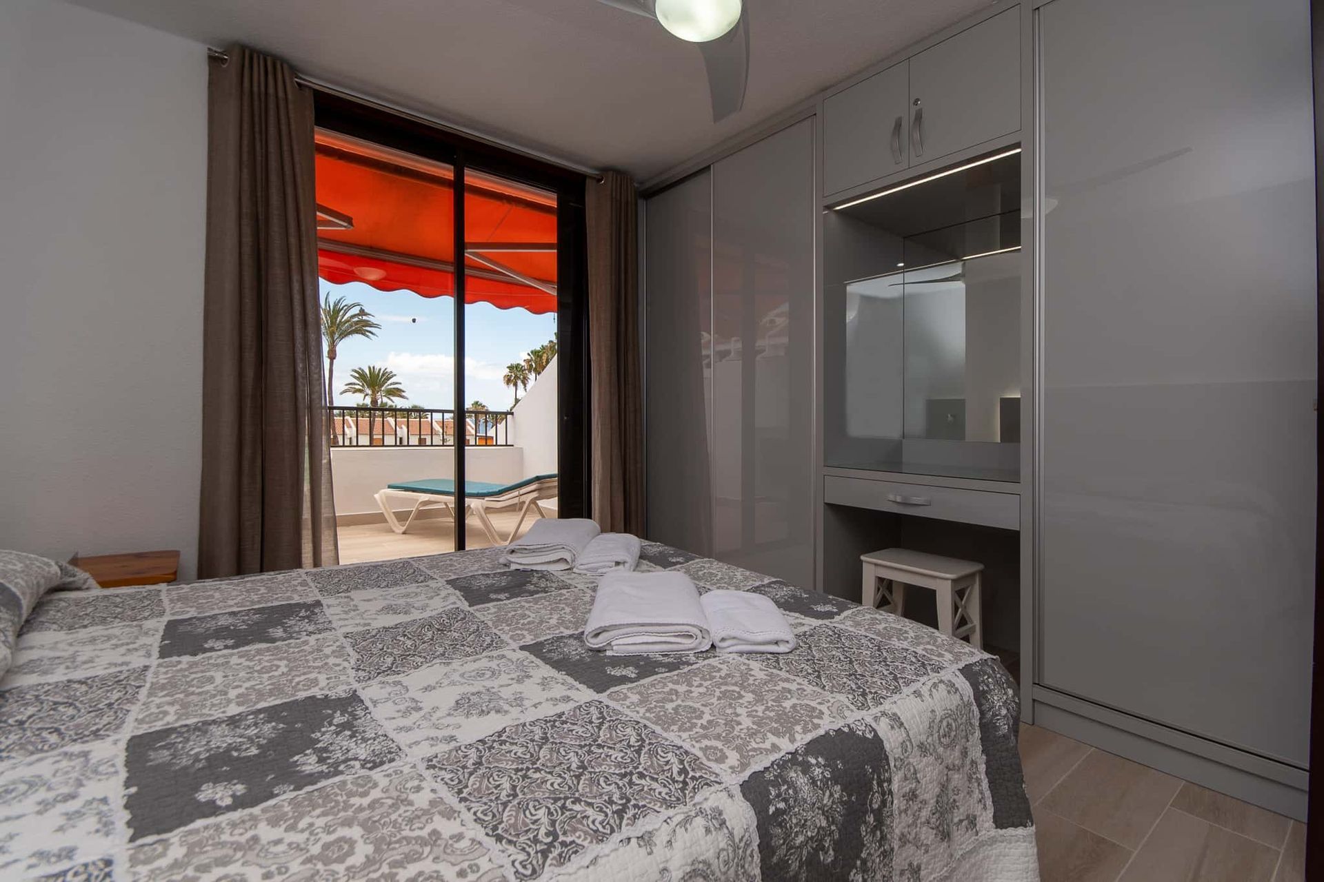 Bedroom with double bed, balcony with sun lounger and sun awning at Parque Santiago II, Playa de las Americas, Tenerife