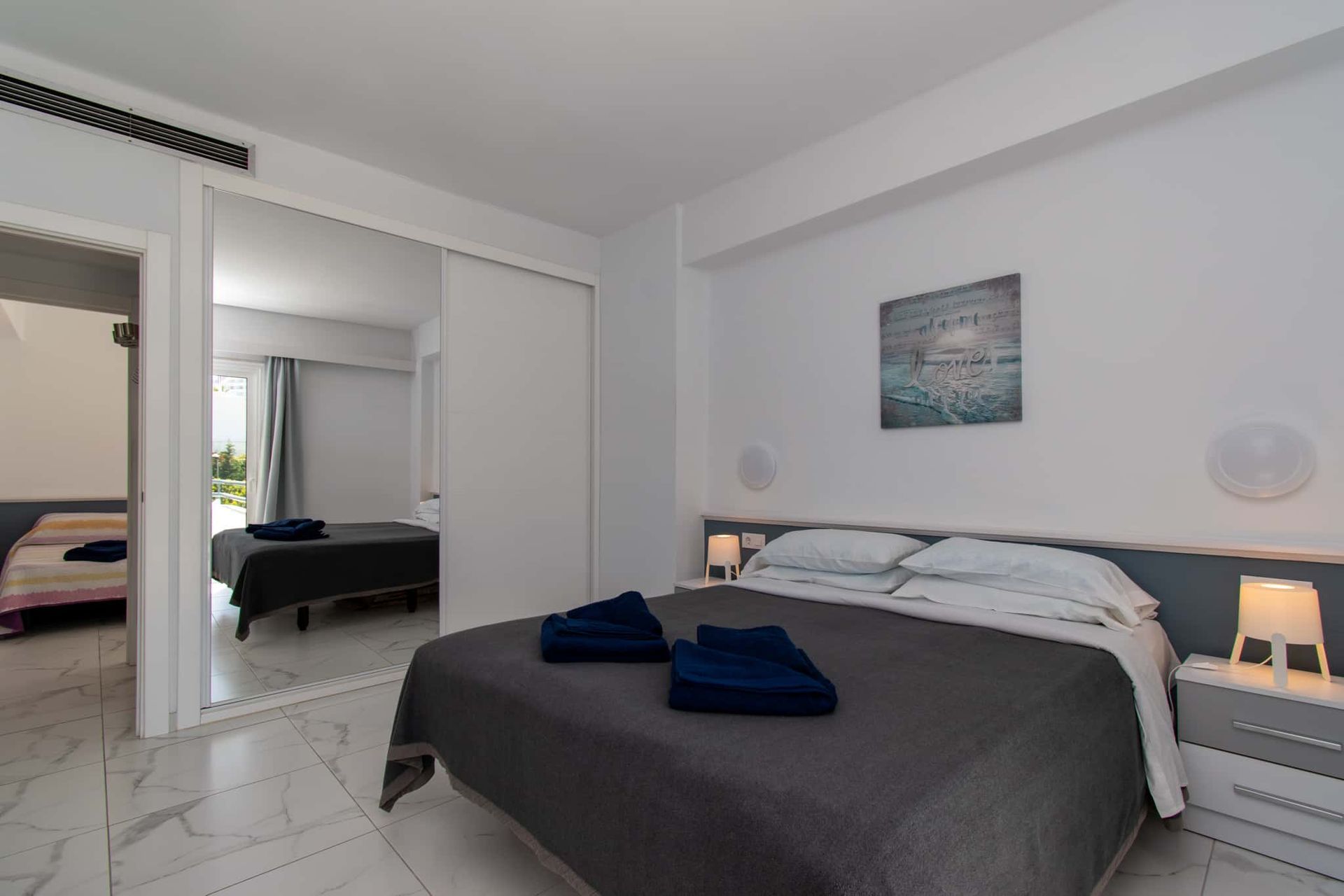 Bedroom with double bed, mirrored wardrobes, Club Atlantis, Costa Adeje, Tenerife.