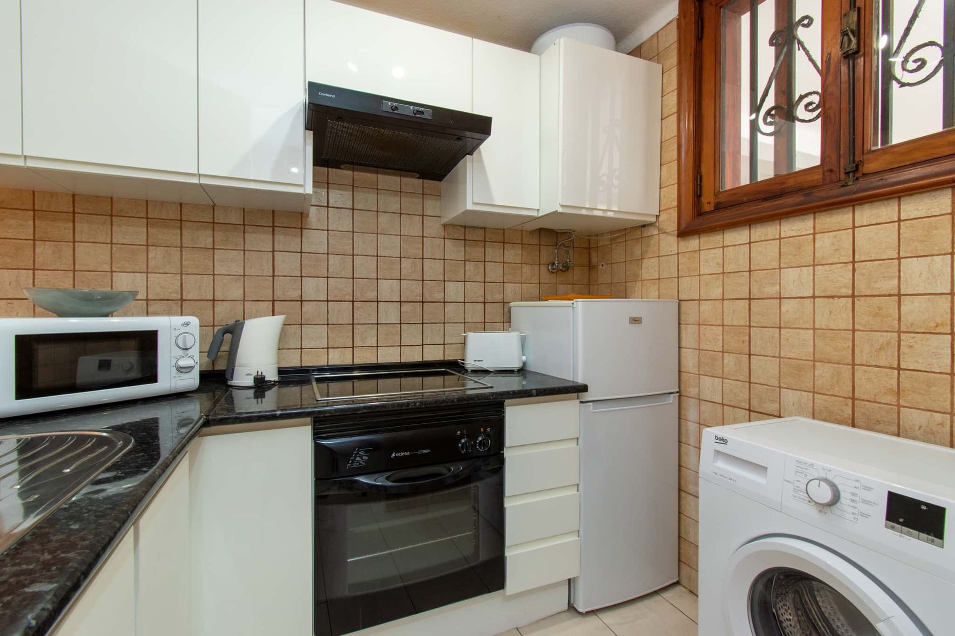 Kitchen with oven, hob, microwave, tall fridge/freezer, extractor fan, washing machine, Parque Santiago I, Playa de las Americas, Tenerife