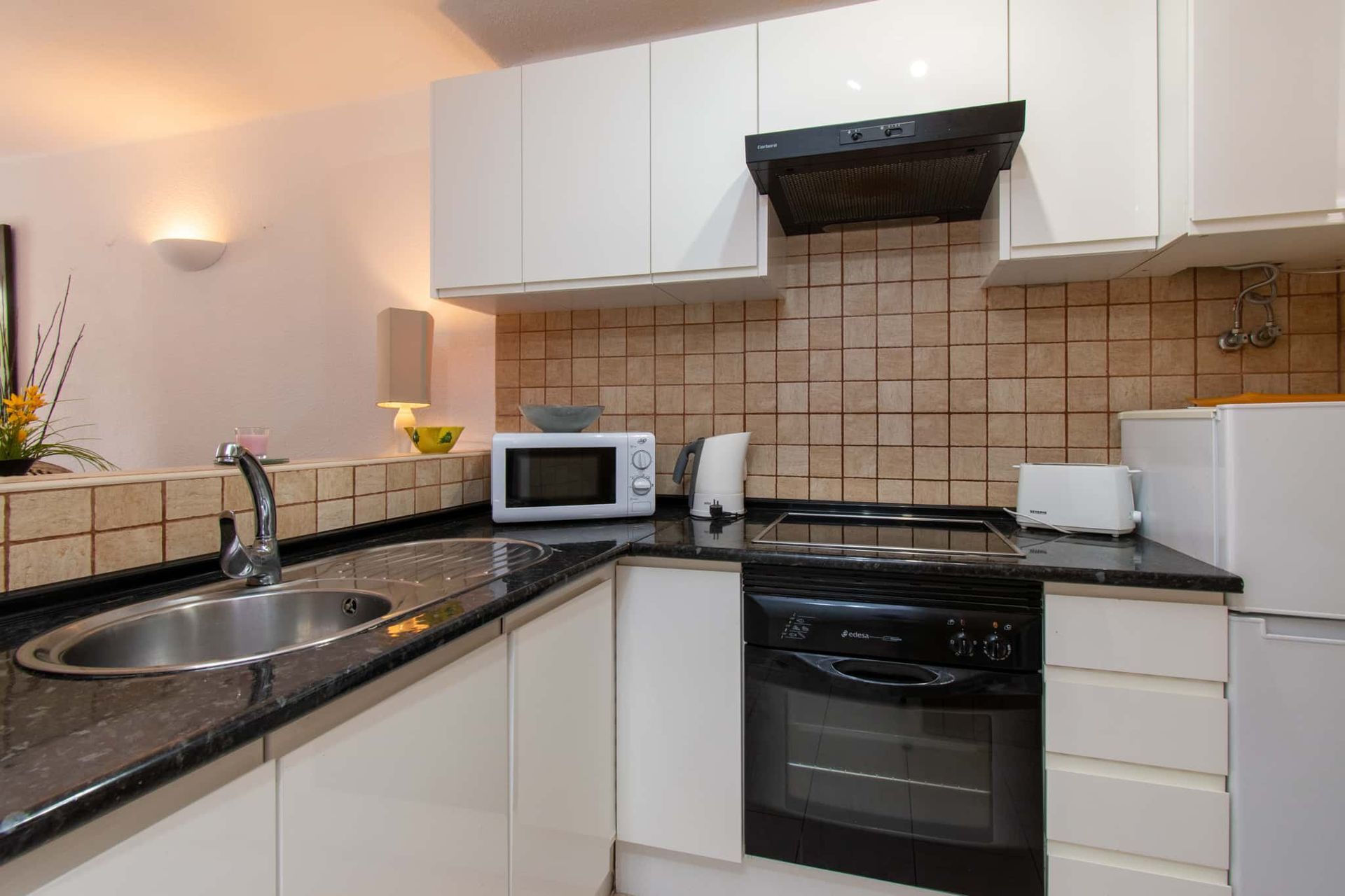 Kitchen with sink, microwave, kettle, toaster, oven, hob, extractor fan, tall fridge/freezer, Parque Santiago I, Playa de las Americas, Tenerife