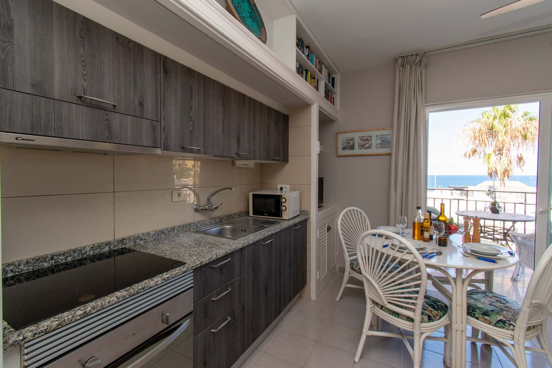 Kitchen with oven, hob, microwave, sink, dining table and chairs, Los Olivos, Costa Adeje, Tenerife.