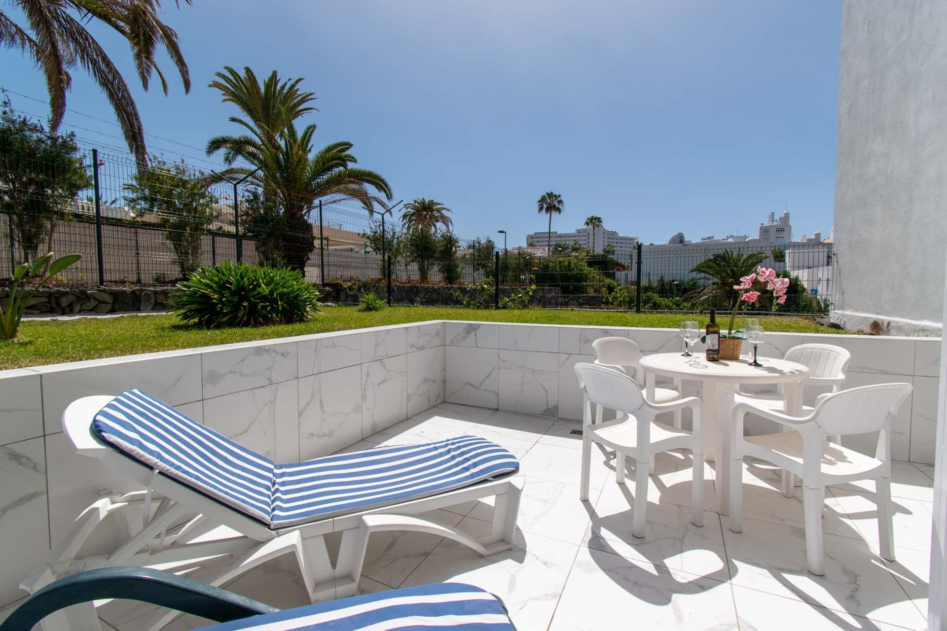 Terrace with sun loungers, patio table and chairs, Club Atlantis, Costa Adeje, Tenerife.