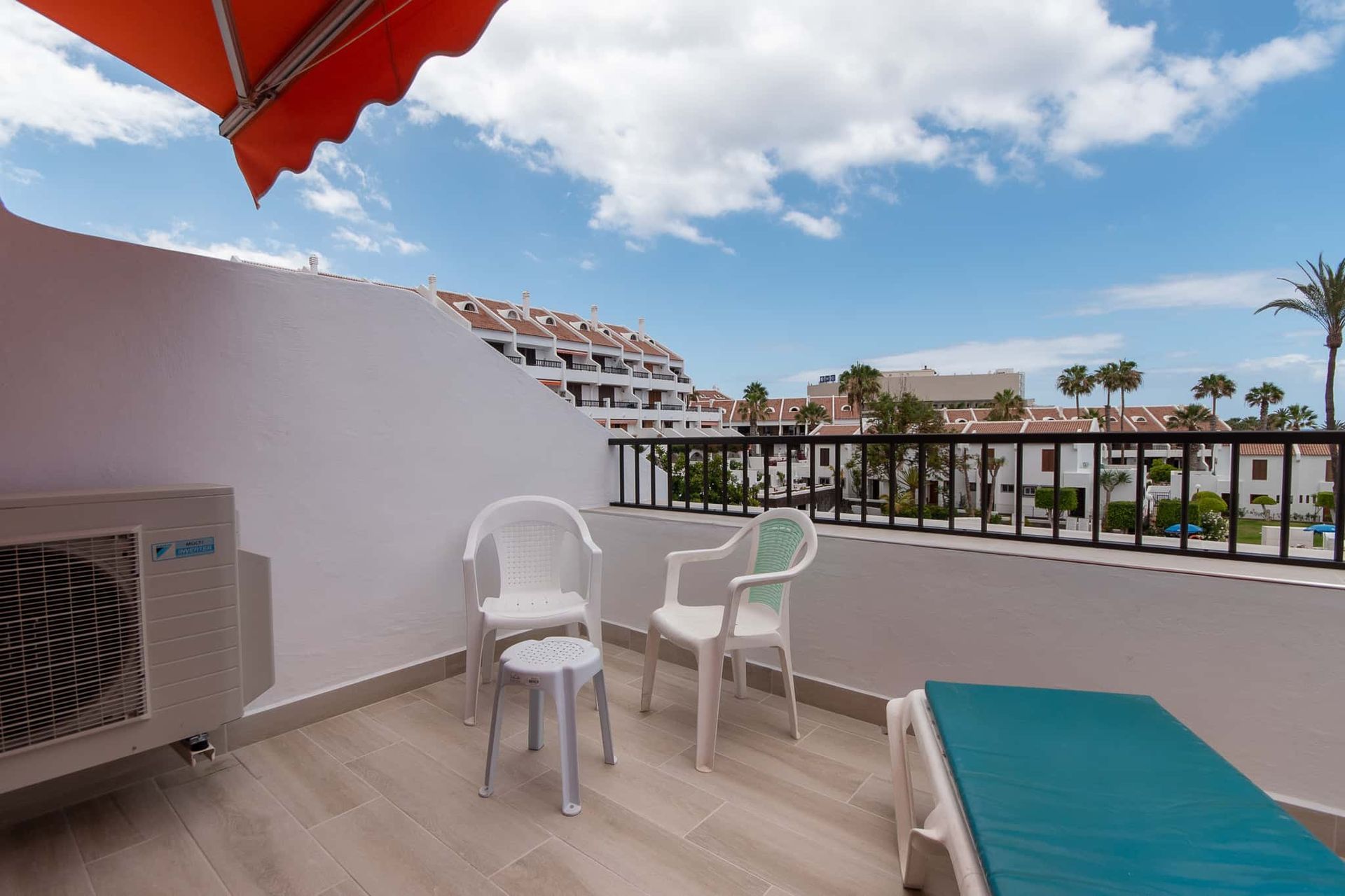 Balcony with sun lounger, chairs with small table at Parque Santiago II, Playa de las Americas, Tenerife