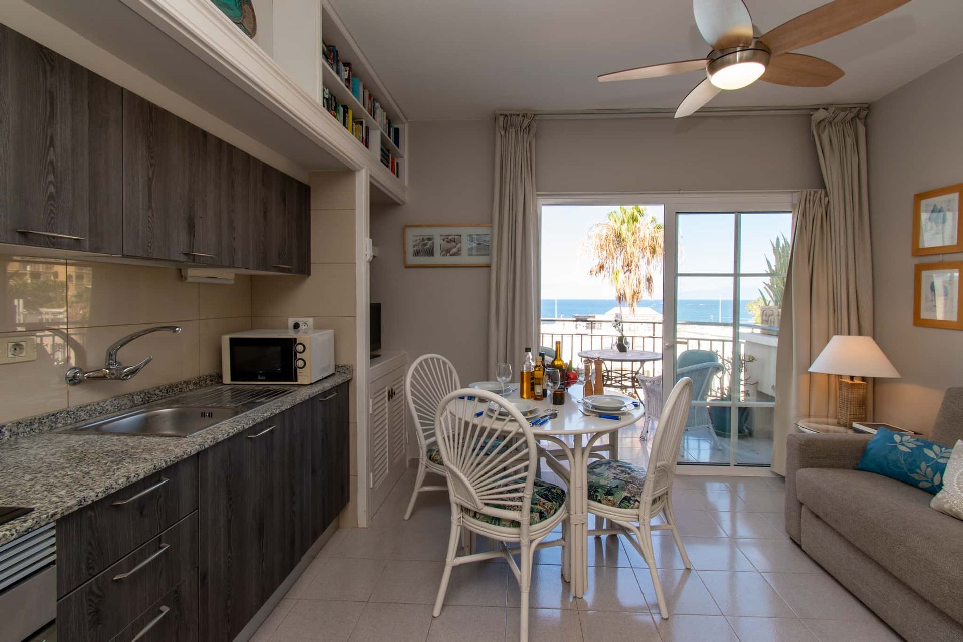 Kitchen with microwave, sink, dining table and chairs, Los Olivos, Costa Adeje, Tenerife.