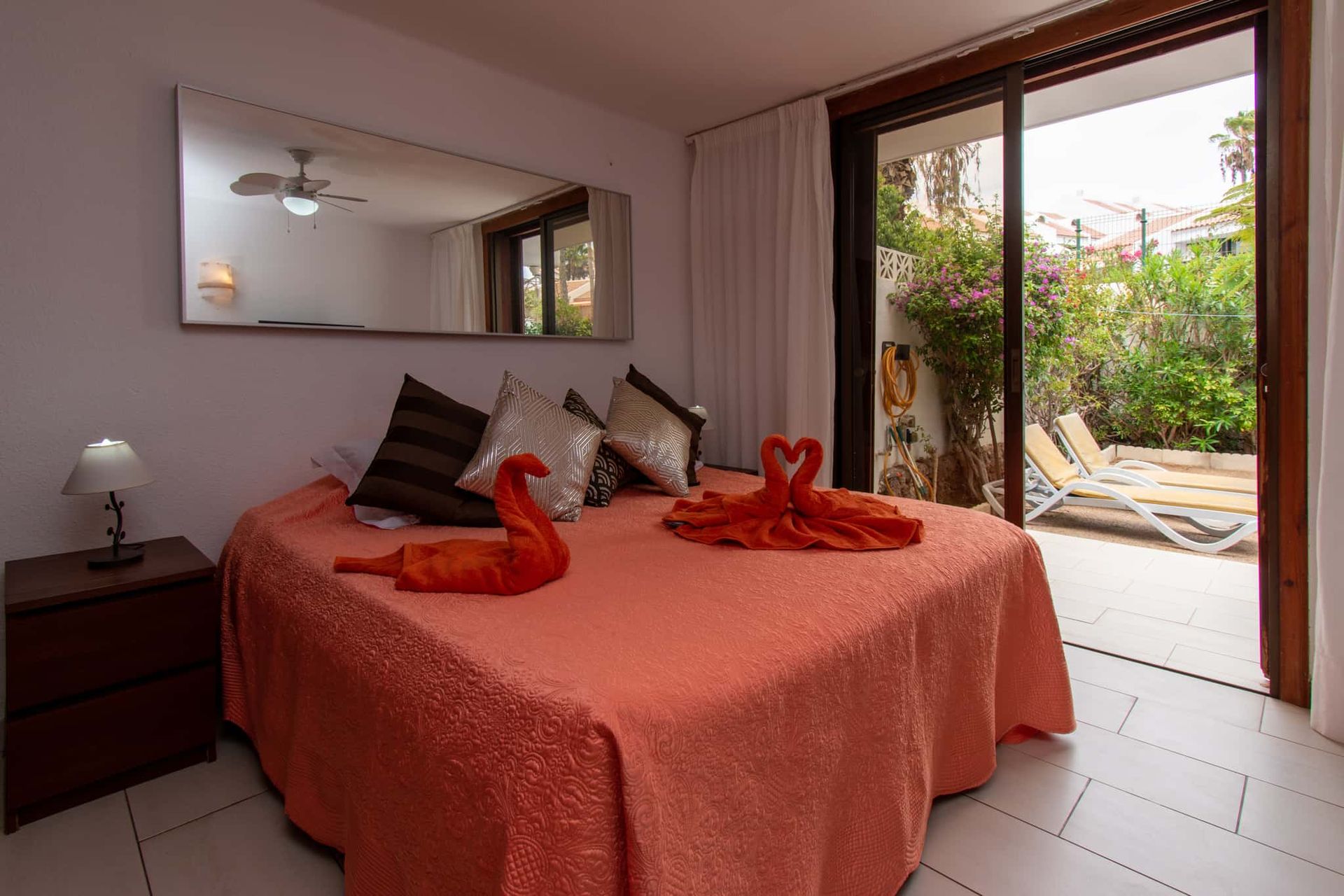 Bedroom with double bed, bedside table with lamp, large mirror, ceiling fan, patio doors leading to terrace, Parque Santiago I, Playa de las Americas, Tenerife