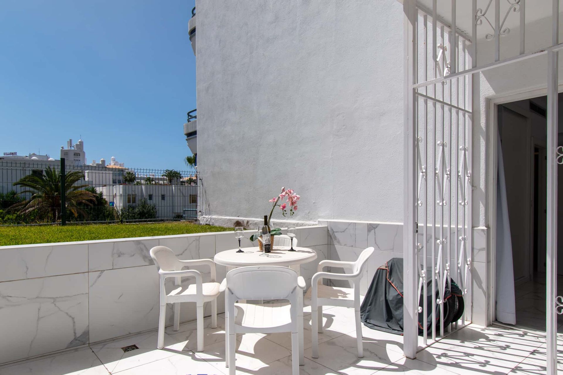 Terrace with patio table and chairs, security grill, Club Atlantis, Costa Adeje, Tenerife.