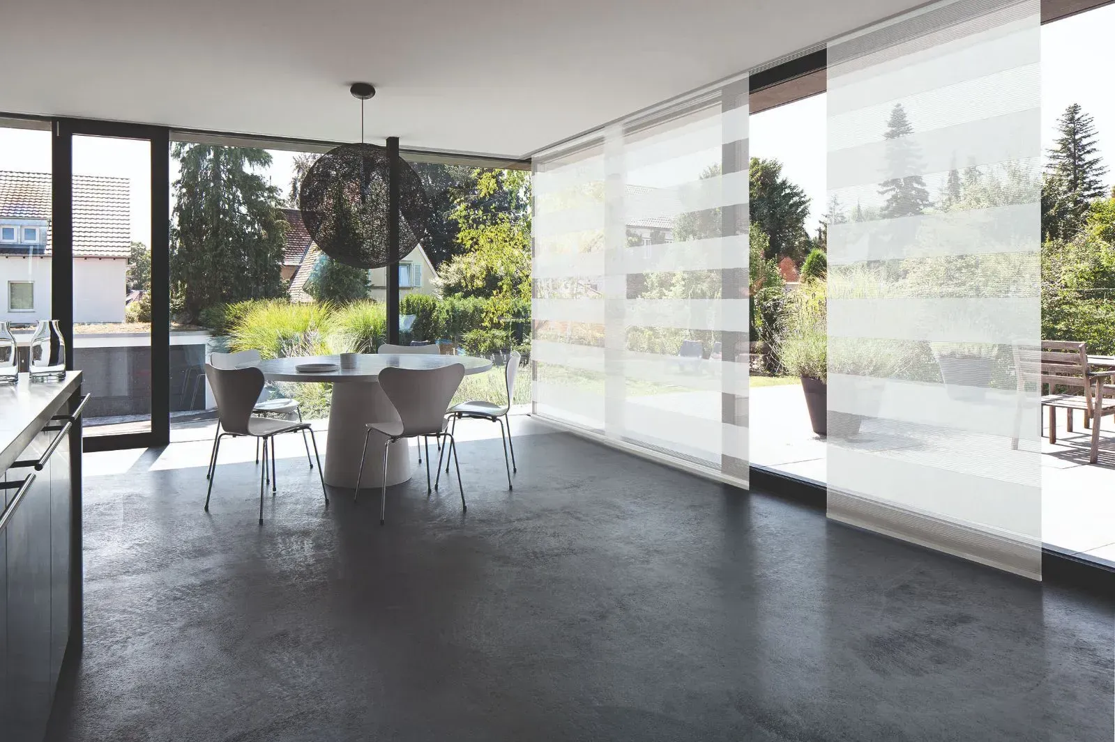 Ein Esszimmer mit Tisch und Stühlen und Glasschiebetüren