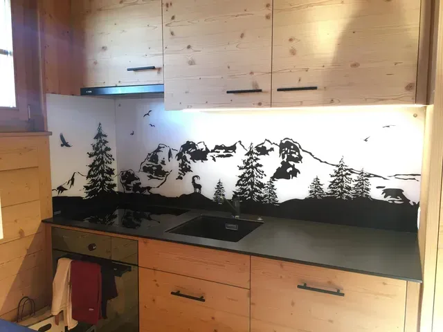 Cuisine en bois avec plan de travail noir, évier