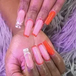 A close up of a woman 's nails with a flower design on them.