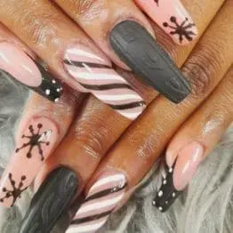 A close up of a person 's nails with different designs on them.