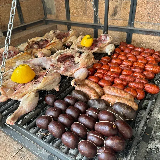 Salchichas de pollo y pimientos se cocinan en una parrilla