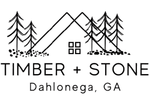 Logo for Timber + Stone, featuring a cabin outline within mountains, trees, and the city of Dahlonega, GA.