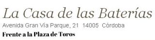 Business sign for La Casa de las Baterías in Córdoba, located at Avenida Gran Via Parque, 21, across from the bullring.