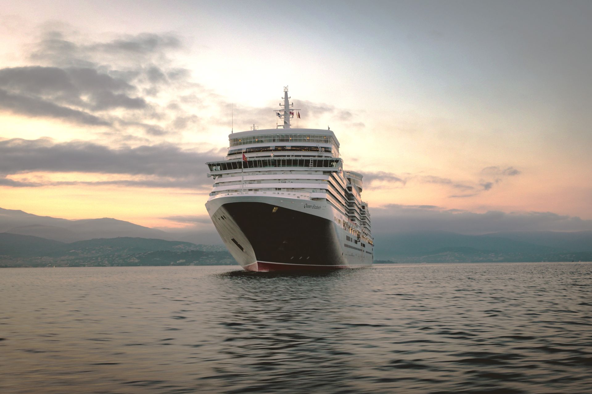 Queen Elizabeth cruise ship sailing at sunset on a Cunard voyage