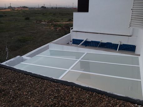 Un edificio blanco con un techo cubierto de vidrio.