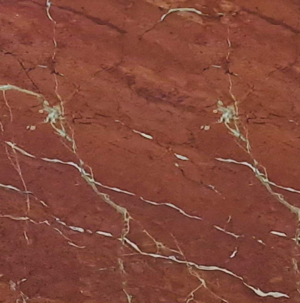 Un primer plano de un azulejo beige con una textura granulada.