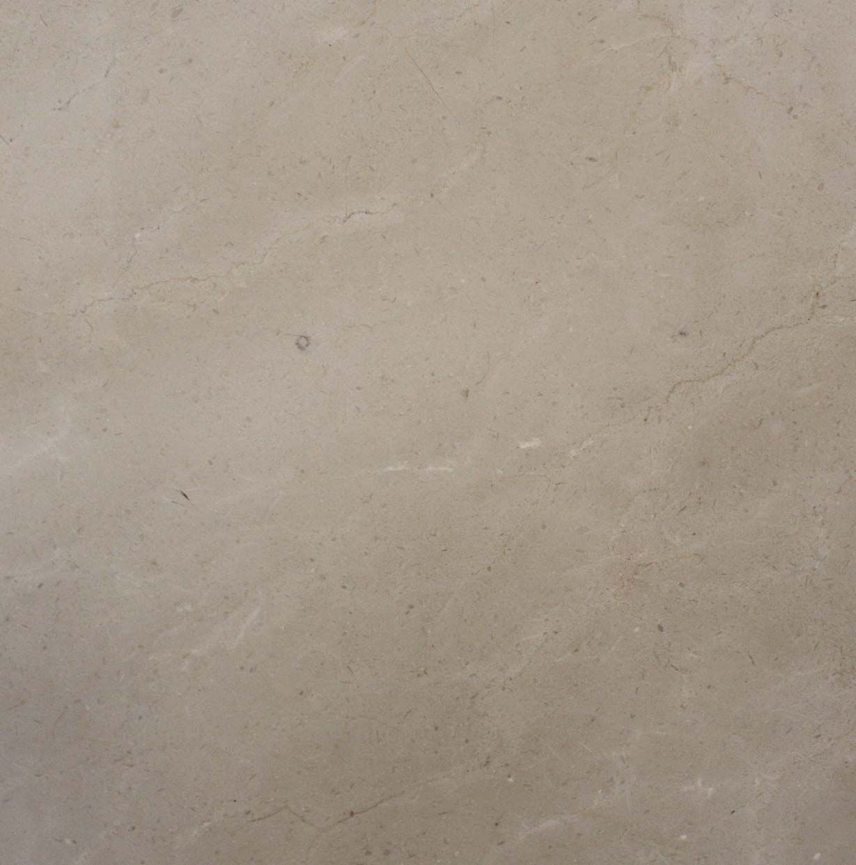 Un primer plano de un azulejo beige con una textura granulada.