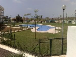 Una gran piscina en medio de un exuberante campo verde